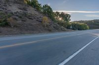 Scenic Road at Dawn with Trees and Hills