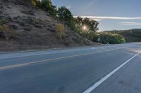 Scenic Road at Dawn with Trees and Hills