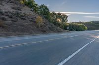 Scenic Road at Dawn with Trees and Hills