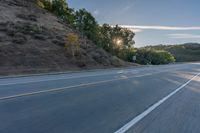 Scenic Road at Dawn with Trees and Hills