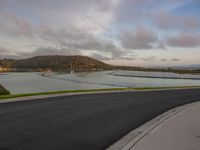 the ocean with water and hills in the background and a boat going down the river