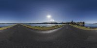 some street and a lake under the sun and a cloud filled sky that looks like some circles