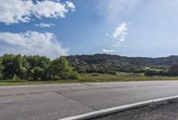 Scenic Road with Lush Landscape and Clear Sky