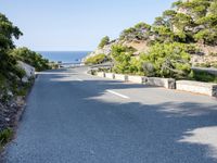 the road goes around the mountain to the sea and the green trees on the cliff
