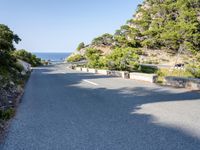 the road goes around the mountain to the sea and the green trees on the cliff