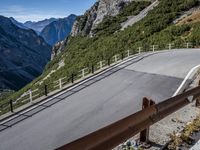 a road windscreens in the distance with a mountainous background and trees below it