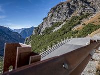 a road windscreens in the distance with a mountainous background and trees below it