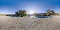 a panorama is pictured as it moves through the sand at the edge of a river