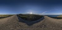 there is a 3d style view from below of a desert hill with water in the distance