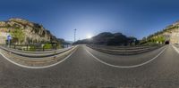 an old curved road with a very steep mountain in the background at sunset time,