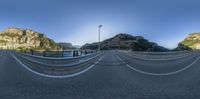 a 360 - view view of a mountain road from the side of it is a very long way