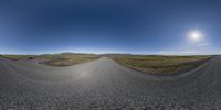 360 lens shot on a roadway with hills in the background and mountains in the distance