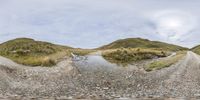 this is a 360 - view photo of an old, rural road near a mountain