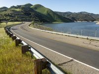 a scenic road along a large body of water with a mountain in the background in rural western nevada