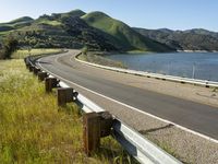 a scenic road along a large body of water with a mountain in the background in rural western nevada