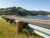 a scenic road along a large body of water with a mountain in the background in rural western nevada