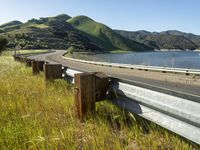 a scenic road along a large body of water with a mountain in the background in rural western nevada