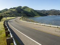 a scenic road along a large body of water with a mountain in the background in rural western nevada