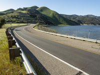 a scenic road along a large body of water with a mountain in the background in rural western nevada