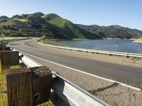 a scenic road along a large body of water with a mountain in the background in rural western nevada