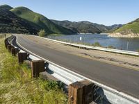 a scenic road along a large body of water with a mountain in the background in rural western nevada