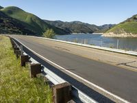 a scenic road along a large body of water with a mountain in the background in rural western nevada