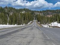 A Scenic Road Leading to Snowy Mountains and a Lake