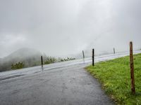 Scenic Road in Switzerland with Fog Covered Mountains