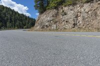 road with a very steep cliff in the distance and yellow line between lines indicating where it should be used