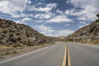 the view from a motorcycle is going down a desert road, as seen from a vehicle's side