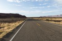 the road is empty and empty in the desert land, and it looks empty from the perspective