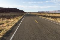 the road is empty and empty in the desert land, and it looks empty from the perspective