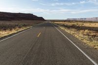 the road is empty and empty in the desert land, and it looks empty from the perspective