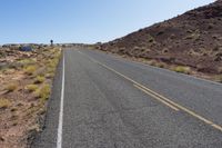 a lone country road with mountains in the background in southwest nevada near las crucet