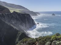 a steep cliff overlooks the ocean in this landscaped view at high speeds in the mountains and cliffs of big sur region