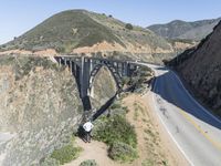 a view of the ocean as a train travels over the bridge over a cliffside