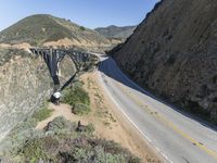 a view of the ocean as a train travels over the bridge over a cliffside