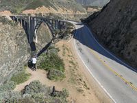 a view of the ocean as a train travels over the bridge over a cliffside