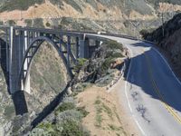 a view of the ocean as a train travels over the bridge over a cliffside