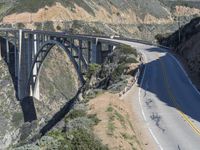 a view of the ocean as a train travels over the bridge over a cliffside