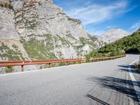 a long narrow highway with mountains behind it and the road below the curves on it