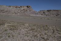 view of the area, including a river bed, rock walls, and scrub grass