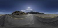 a long winding road with a sunny sky in the background in the middle of the image