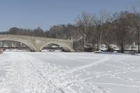 Scenic Winter Landscape in Canada with Frozen Lake and Arch Bridge