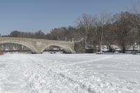 Scenic Winter Landscape in Canada with Frozen Lake and Arch Bridge