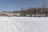 Scenic Winter Landscape in Canada with Frozen Lake and Arch Bridge