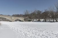 Scenic Winter Landscape in Canada with Frozen Lake and Arch Bridge