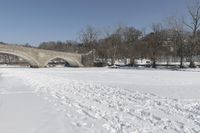 Scenic Winter Landscape in Canada with Frozen Lake and Arch Bridge