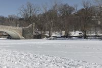 Scenic Winter Landscape in Canada with Frozen Lake and Arch Bridge