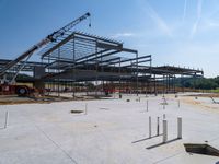 the construction site at the school is being constructed with metal rods and poles as they sit next to the open air